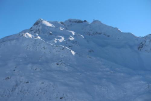 a mountain covered in snow on a clear day at BnB Bellavista Apartment in Andermatt