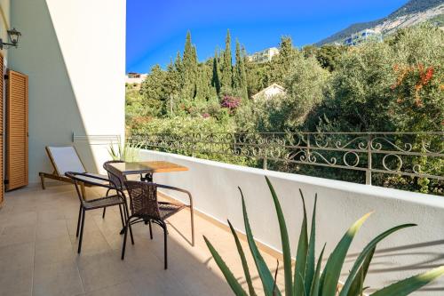 a patio with a table and chairs on a balcony at La Signora Hotel in Lourdhata
