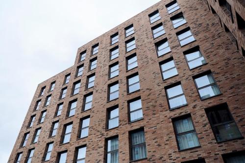 a tall brick building with lots of windows at Canvas Glasgow in Glasgow