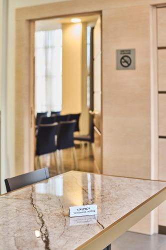 a table with a sign sitting on top of it at Hotel Da Vinci in Vinci