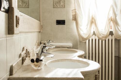a bathroom with a sink and a toilet at Bed & Breakfast AMATI in Fasano