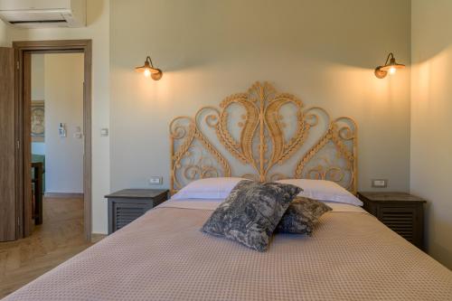 a bedroom with a large bed with two pillows on it at La Signora Hotel in Lourdhata