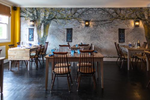 a dining room with wooden tables and chairs at La Fosse at Cranborne in Cranborne