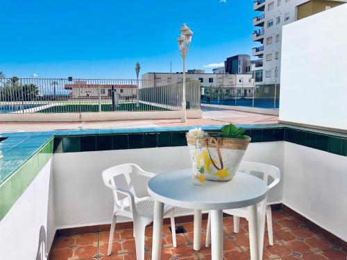 a table and chairs on a balcony with a pool at Peñiscola playa in Peñíscola