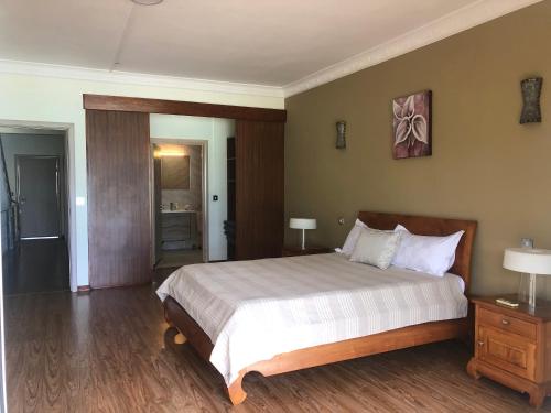 a bedroom with a large bed in a room at Ocean-view penthouse with roof terrace, Grand Baie, Waterside complex in The Vale