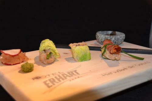 a plate of sushi on a table with chopsticks at Hotel Erhart Sölden in Sölden