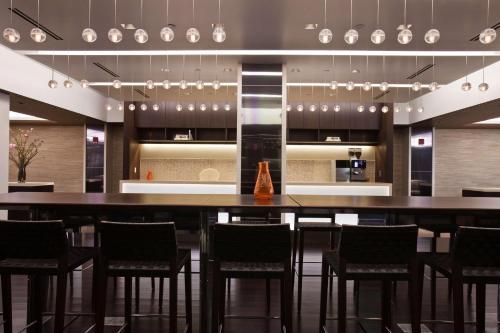 a large kitchen with a bar with stools in it at Hyatt Grand Central New York in New York