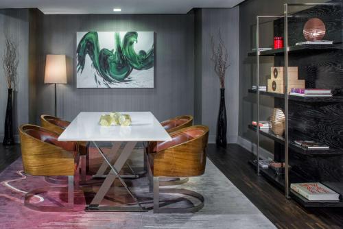 a dining room with a white table and chairs at Hyatt Grand Central New York in New York