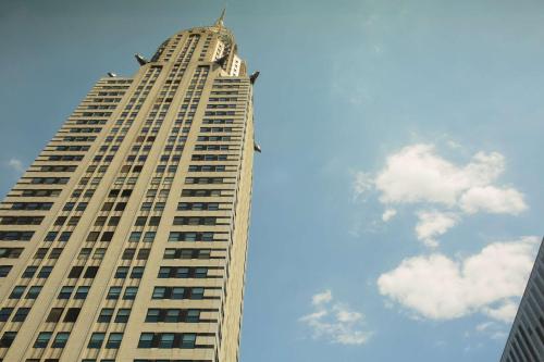 a tall building with a clock on the top of it at Hyatt Grand Central New York in New York
