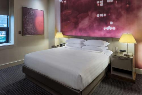 a large white bed in a hotel room at Hyatt Grand Central New York in New York