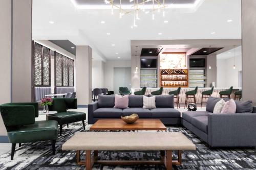 a lobby with couches and chairs and a table at Hyatt House Charlotte Rea Farms in Charlotte