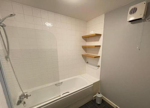 a bathroom with a shower and a tub and a sink at One bedroom with Great city views in London