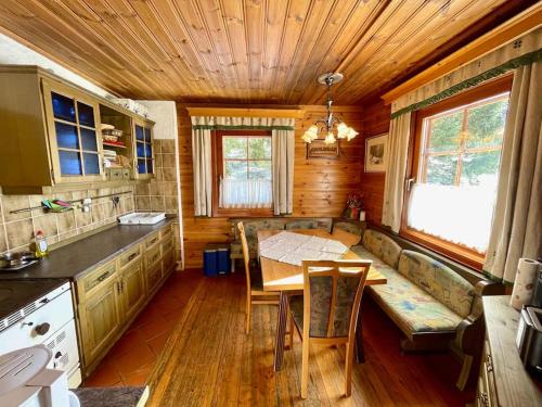 a kitchen with a table and a couch in a room at Axterhütte 