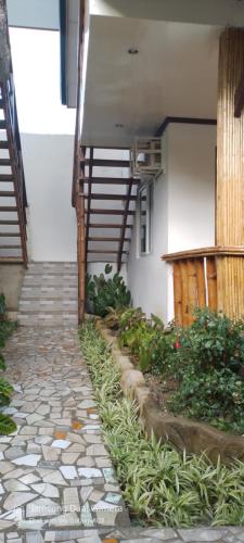 a stone walkway leading to a building with a staircase at Dhadas place in San Vicente