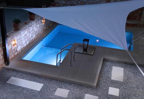 an overhead view of a swimming pool in a house at night at LaCasa 1 Deluxe Villa with Pool and Jacuzzi in Roumelí