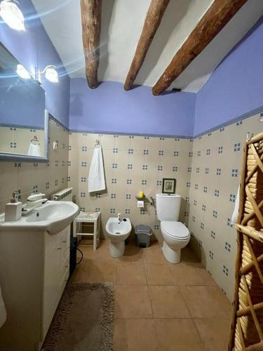 a bathroom with a toilet and a sink and a toilet istg at Alojamiento rural La Casona in Andorra