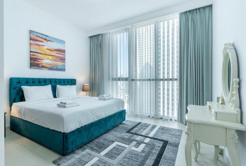 a bedroom with a bed and a desk and a mirror at Luxury I Free Weekly Housekeeping I 5 Mins to Dubai Mall in Dubai
