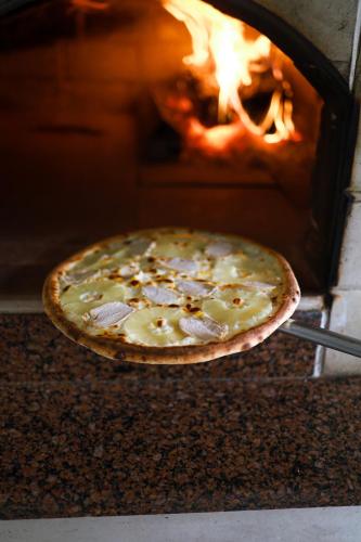 a pizza is being cooked in an oven at Continental SPA Resort in Bukovel