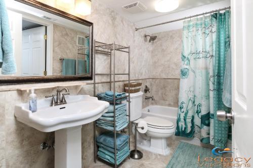 a bathroom with a sink and a toilet and a shower at SO 101 - Large 3 BR Beachfront Ground Floor Condo in Fort Walton Beach
