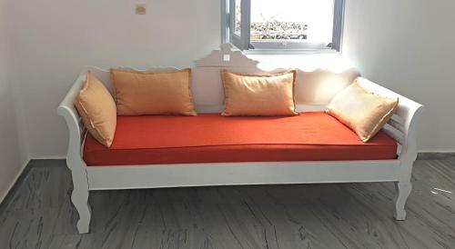 a white bed with pillows on it in a room at Phaos Santorini Suites in Imerovigli