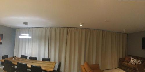 a room with a curtain and a table and chairs at Reykjavík City Town Apartments in Reykjavík