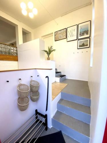 a staircase in a house with baskets on the wall at Aekta Studio apartments Gothenburg in Gothenburg