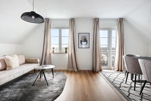a living room with a couch and a table at Charm 2 - Great 2-Bdr Apt with Shared Garden and Balcony in Copenhagen