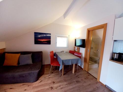 a living room with a table and a couch at Dorf.Apart in Neustift im Stubaital