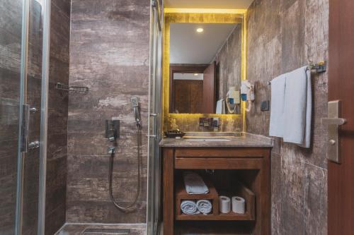 a bathroom with a sink and a shower at Manaspark Deluxe Hotel in Oludeniz