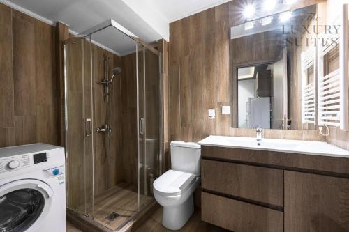 a bathroom with a toilet and a shower and a sink at Adelle Apartments, The Luxury Suites in Thessaloniki