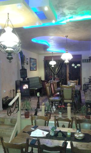 a living room with tables and chairs and lights at Семеен Хотел Русалка in Svishtov