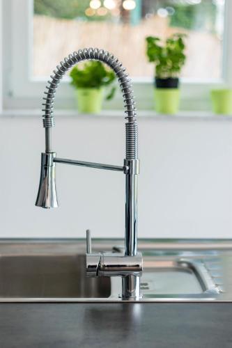 a kitchen sink with a chrome kitchen faucet at Ferienwohnung Landurlaub in Irsch