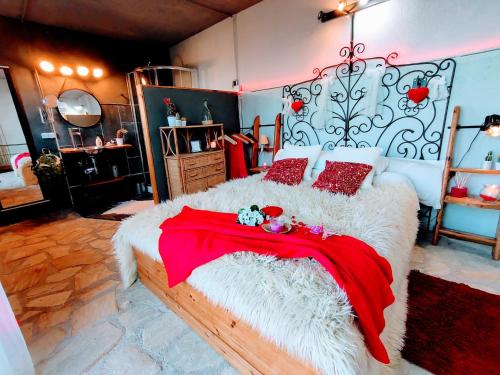 a bedroom with a large bed with a red blanket at Romantic Nest lloret in Lloret de Mar