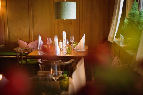 a table in a restaurant with wine glasses at Hotel Gasthof Brandstätter in Salzburg