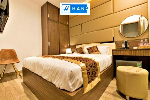 a hotel room with a bed and a tv at HANZ MyMy Hotel in Ho Chi Minh City