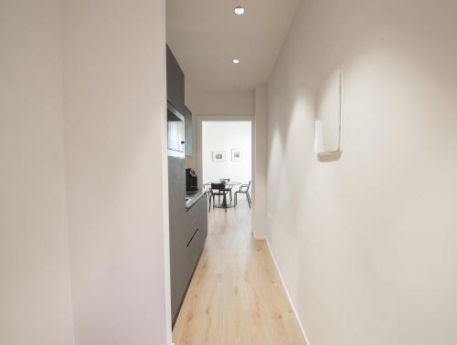 a hallway with a kitchen and a dining room at San Carlo Suite Torino in Turin