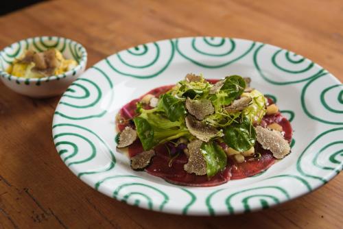 a plate of food on a wooden table at Hotel Gasthof Brandstätter in Salzburg