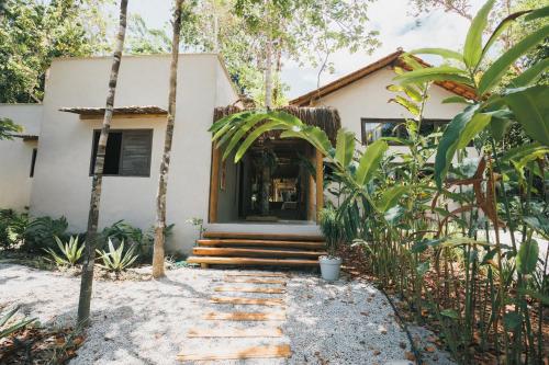 a house in the middle of a garden at CASA SUKHA Hotel in Trancoso