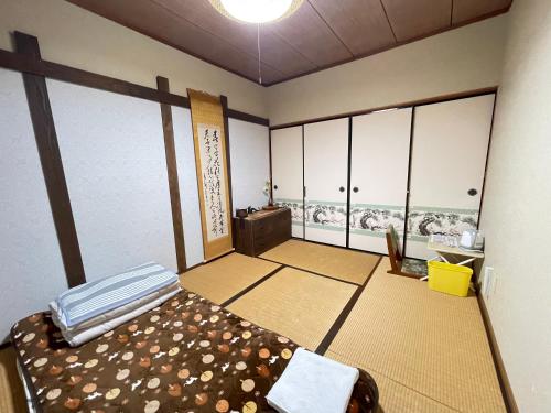 a room with a bed and a tv in it at Shiga Biwa Lake Shanshui House in Takashima