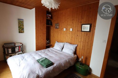 a bedroom with a bed with a green pillow on it at Chalet LES MARMOTTES, Ovronnaz in Ovronnaz