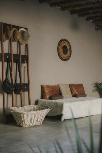 a living room with a bed and a basket at CASA SUKHA Hotel in Trancoso