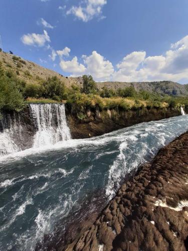 a waterfall on the side of a river at Bosnian Villa in Hadžići