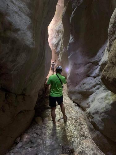 two people walking through a slot canyon at Bosnian Villa in Hadžići