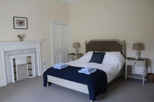 a bedroom with a bed with two towels on it at Oldwood. Fyvie. in Turriff