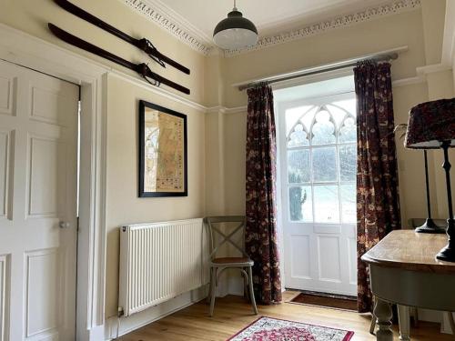 a room with a door and a window at Oldwood. Fyvie. in Turriff