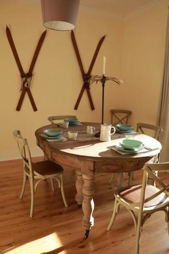a dining room with a wooden table and chairs at Oldwood. Fyvie. in Turriff