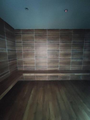 an empty room with wooden floors and a wall at Kuching Luxurious Town Area Apartment in Kuching
