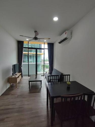 a living room with a table and a couch at Kuching Luxurious Town Area Apartment in Kuching