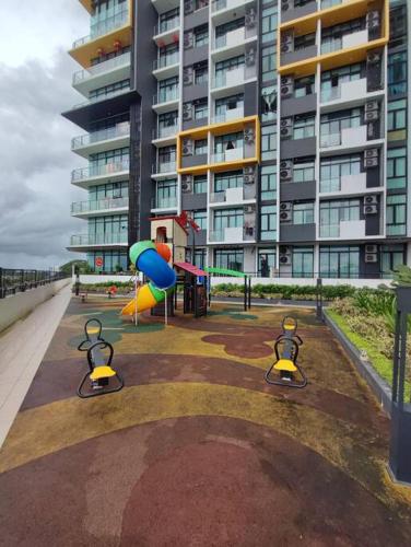 a painting of a playground in front of a building at Kuching Luxurious Town Area Apartment in Kuching