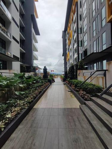 an empty walkway between two tall buildings at Kuching Luxurious Town Area Apartment in Kuching